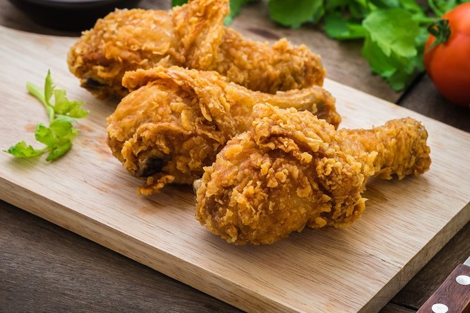Crispy fried chicken on wooden cutting board and dip sauce